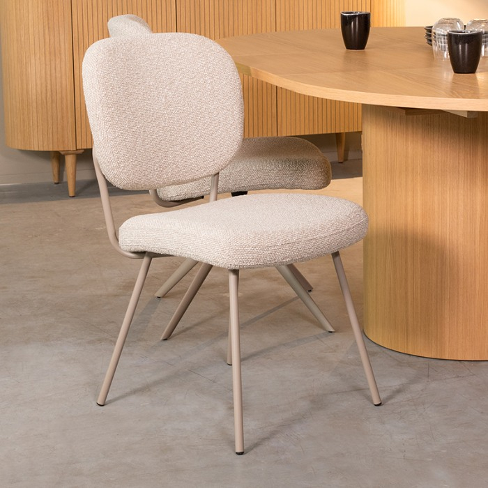 Eetkamerstoel Sem in crème bouclé met taupe poten aan de eettafel